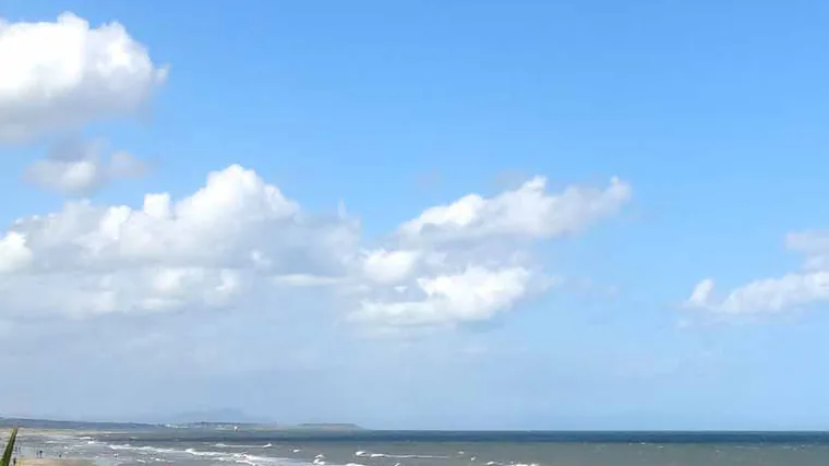 Sandy beach and blue sea under a bright sky on the Boyne Valley coast