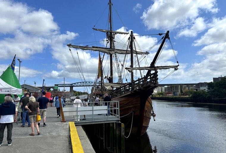 Nao Santa María replica docked at Drogheda with the Boyne Viaduct behind and visitors on the pier