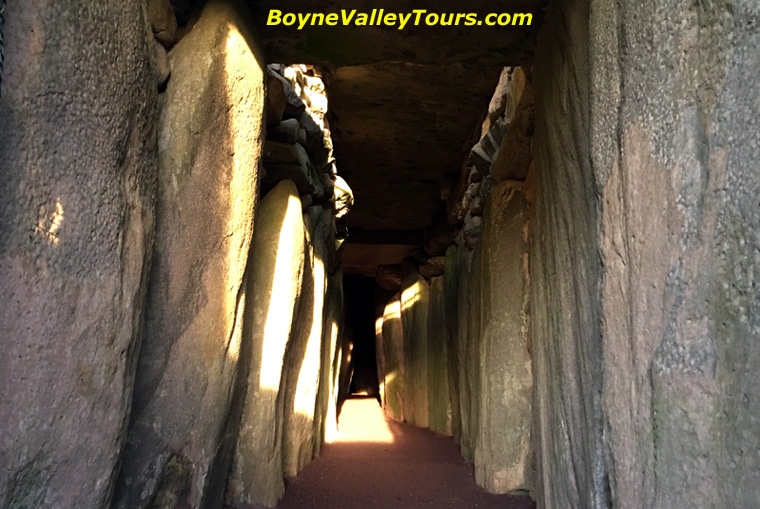 It's the higher sunbeam from the 'Roofbox' that illuminates the chamber inside Newgrange.